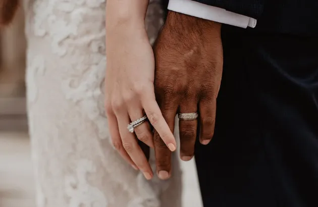 A couple wearing a couple ring.